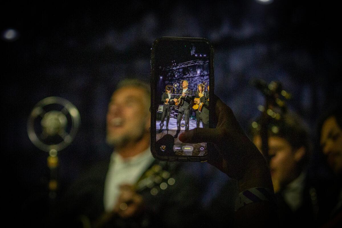 A fan snaps a photo of Nick Hexum at The Waiting Room Lounge in Omaha.